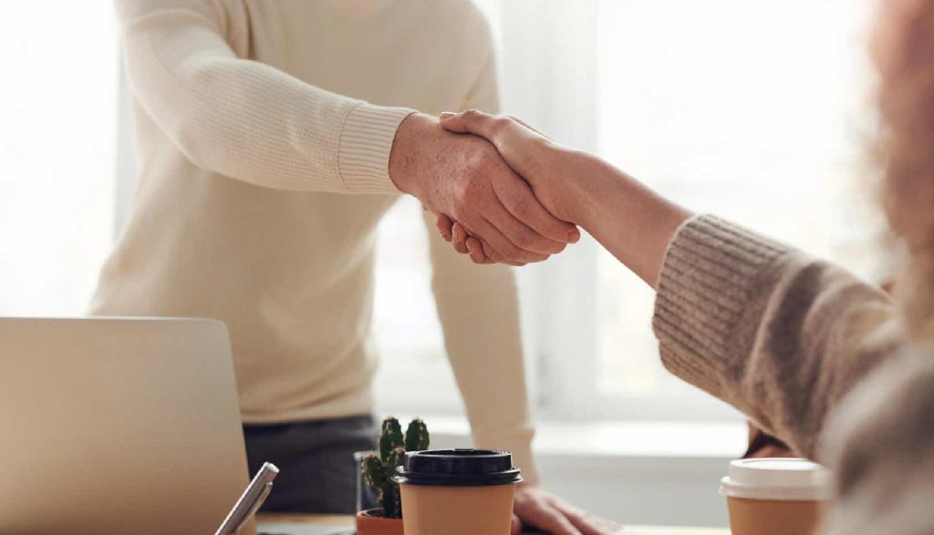 Handshake with a customer, demonstrating respect, trust, and a warm welcome to build lasting business relationships